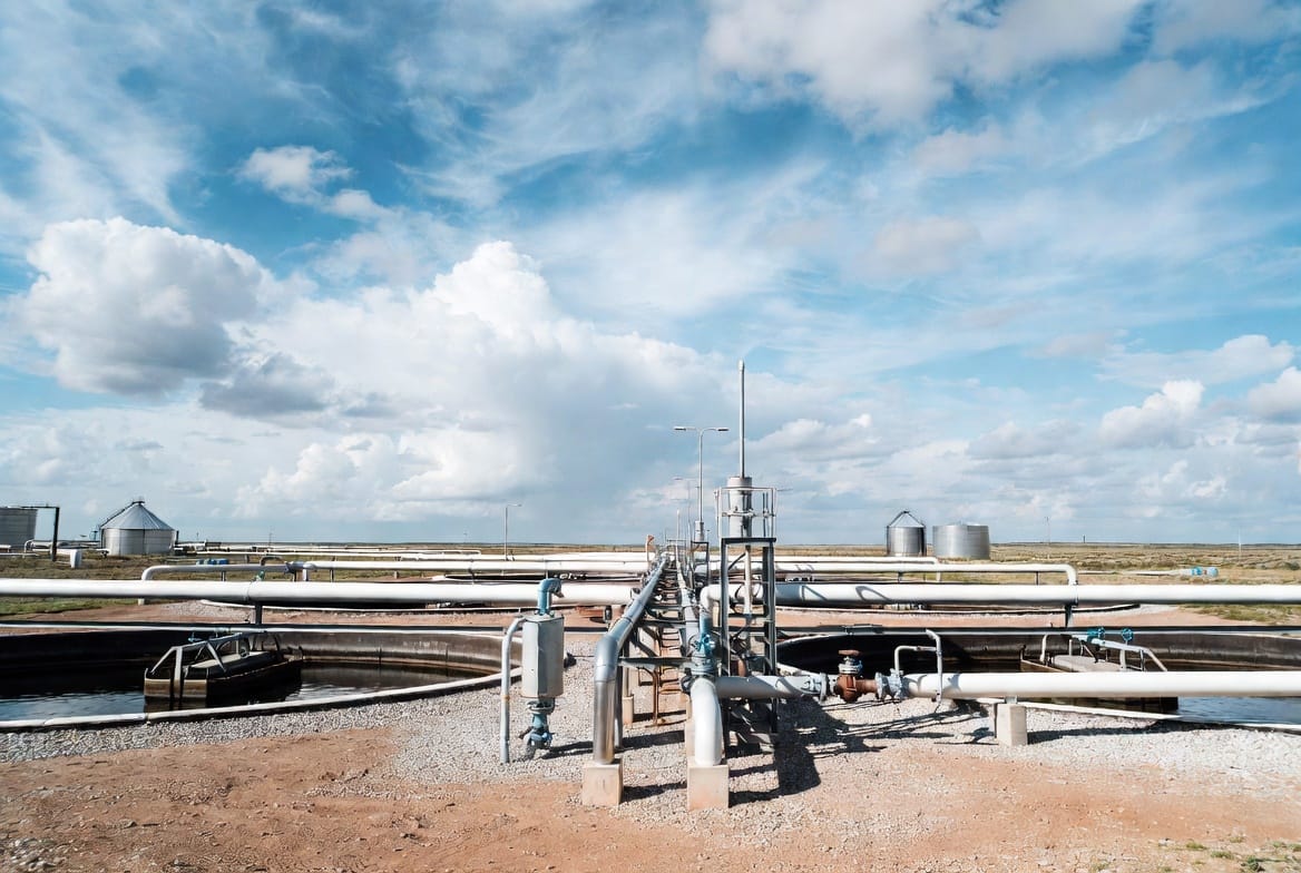 VANCE oilfield sewage treatment equipment trailer-mounted produced water treatment system in field operation at remote oilfield production site showing complete treatment train including separator inlet, flotation unit, filtration vessels, and clean water discharge outlet